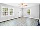 A bright living room showcasing vintage flooring and a ceiling fan, complemented by natural light from windows at 504 Delaware Ave, Burlington, NC 27217