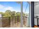 Balcony view overlooking lush greenery, with a partial view of the kitchen and blue window coverings at 515 N Mangum St # 41, Durham, NC 27701