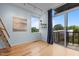 Bright bedroom with hardwood floors, a serene painting, and a sliding door to a balcony at 515 N Mangum St # 41, Durham, NC 27701
