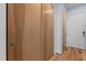 Hallway with wood flooring and wood closet doors gives a clean and organized look to the home at 515 N Mangum St # 41, Durham, NC 27701