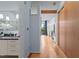 View down the hallway, showing a partial bathroom and the kitchen in the background at 515 N Mangum St # 41, Durham, NC 27701