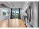 Bright open floorplan featuring a modern kitchen with stainless steel appliances and sliding glass doors to a balcony at 515 N Mangum St # 41, Durham, NC 27701