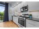 Well-lit kitchen featuring sleek stainless steel appliances, white cabinets, and a modern backsplash at 515 N Mangum St # 41, Durham, NC 27701