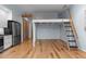 Open living space with hardwood floors, a stainless steel refrigerator, and a loft bed setup at 515 N Mangum St # 41, Durham, NC 27701
