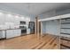Open living space with modern kitchen, hardwood floors, and a unique lofted bed structure at 515 N Mangum St # 41, Durham, NC 27701