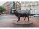 Bronze bull sculpture on a brick pedestal in an urban setting at 515 N Mangum St # 41, Durham, NC 27701