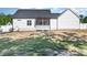 Backyard featuring a screened-in patio, partial grass and white vinyl privacy fence surrounding the yard at 57 S Shreve Dr, Wendell, NC 27591