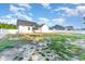 Expansive backyard with a white privacy fence, green grass, and a screened-in patio extending from the home at 57 S Shreve Dr, Wendell, NC 27591