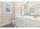 A bright bathroom features white cabinetry, modern fixtures, and a walk-in shower at 57 S Shreve Dr, Wendell, NC 27591