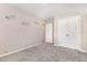 Bedroom with neutral walls, plush carpeting, decorative wall decals, double door closet and entrance to en-suite bathroom at 57 S Shreve Dr, Wendell, NC 27591
