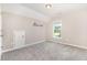 Cozy bedroom with vaulted ceilings, neutral walls, carpet, one window and 'Adventure Awaits' decoration on the wall at 57 S Shreve Dr, Wendell, NC 27591