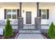 Inviting front porch with stone columns and a decorated front door entrance at 57 S Shreve Dr, Wendell, NC 27591