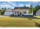 Charming one-story home with a manicured lawn, stone accents, and an inviting front porch at 57 S Shreve Dr, Wendell, NC 27591