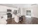 Well-lit kitchen boasts stainless steel appliances, granite countertops, and a modern island at 57 S Shreve Dr, Wendell, NC 27591