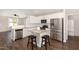 Contemporary kitchen with stainless steel appliances, white cabinets, and an island with seating at 57 S Shreve Dr, Wendell, NC 27591