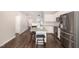 Well-lit kitchen with white cabinets, granite countertops, and stainless steel appliances at 57 S Shreve Dr, Wendell, NC 27591