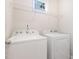 Functional laundry room with white appliances and a convenient overhead shelf at 57 S Shreve Dr, Wendell, NC 27591