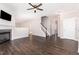 Spacious living room featuring hardwood floors, a stone fireplace, and neutral paint colors at 57 S Shreve Dr, Wendell, NC 27591