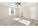 Spacious main bedroom with tray ceilings, carpeted floors, and large windows at 57 S Shreve Dr, Wendell, NC 27591