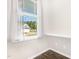 A picturesque window view showcases a charming home exterior with lush greenery at 57 S Shreve Dr, Wendell, NC 27591