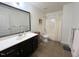Bathroom with large framed mirror, black cabinets, and a shower and tub combination at 59 Tobacco Farm Way, Chapel Hill, NC 27516