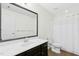 Bathroom featuring a white sink, dark vanity, matching toilet, and shower with curtain at 59 Tobacco Farm Way, Chapel Hill, NC 27516