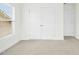 Bedroom featuring neutral colored carpet, bright windows, and a double-door closet at 59 Tobacco Farm Way, Chapel Hill, NC 27516