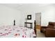 Comfortable bedroom with a bed, reading chair, and an open doorway to an en-suite bathroom at 59 Tobacco Farm Way, Chapel Hill, NC 27516