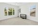 Airy bedroom with large windows and new carpeting featuring a ceiling fan and television at 59 Tobacco Farm Way, Chapel Hill, NC 27516