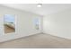 Bright bedroom with plush carpeting and a view from two windows with blinds at 59 Tobacco Farm Way, Chapel Hill, NC 27516