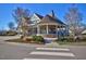 Exterior view of an elegant clubhouse with a stone base, wraparound porch, and manicured landscaping at 59 Tobacco Farm Way, Chapel Hill, NC 27516