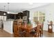 Bright dining area with a wooden table, chairs, and natural light from the window at 59 Tobacco Farm Way, Chapel Hill, NC 27516