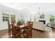 Open-concept dining room adjacent to a living area with a fireplace and ample seating at 59 Tobacco Farm Way, Chapel Hill, NC 27516