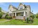 Beautiful home featuring a stone-accented porch with columns and landscaped garden at 59 Tobacco Farm Way, Chapel Hill, NC 27516
