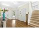 Elegant foyer featuring hardwood floors, a staircase, and ample natural light at 59 Tobacco Farm Way, Chapel Hill, NC 27516
