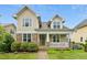 Charming home with a stone and shake exterior, a cozy front porch, and a well-manicured lawn at 59 Tobacco Farm Way, Chapel Hill, NC 27516