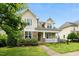 Charming home with a stone and shake exterior, a cozy front porch, and a well-manicured lawn at 59 Tobacco Farm Way, Chapel Hill, NC 27516