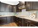 Elegant kitchen featuring dark wood cabinetry, stainless steel appliances, and a light backsplash at 59 Tobacco Farm Way, Chapel Hill, NC 27516