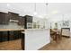 Modern kitchen with dark cabinetry, stainless steel appliances, and an open layout at 59 Tobacco Farm Way, Chapel Hill, NC 27516