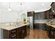Stylish kitchen with dark wood cabinets, stainless steel appliances, and a spacious countertop at 59 Tobacco Farm Way, Chapel Hill, NC 27516