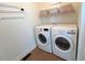 Bright laundry room with modern washer and dryer and shelving at 59 Tobacco Farm Way, Chapel Hill, NC 27516