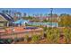 Community pool area with splash pad, sunshades, and decorative elements, surrounded by fencing and trees at 59 Tobacco Farm Way, Chapel Hill, NC 27516