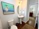 This powder room features a pedestal sink, decorative mirror, and modern lighting at 59 Tobacco Farm Way, Chapel Hill, NC 27516