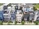 Aerial view showcases the modern white home with a rooftop deck, nestled in a vibrant neighborhood at 606 Velma Hopkins Ln, Raleigh, NC 27603