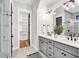 Modern bathroom with double vanity, sleek fixtures, and glass-enclosed shower at 606 Velma Hopkins Ln, Raleigh, NC 27603