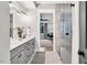 Bright bathroom features double vanity with modern fixtures, large mirror, and tiled floors at 606 Velma Hopkins Ln, Raleigh, NC 27603