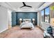 Bedroom with an accent wall, ceiling fan, and large windows for ample light at 606 Velma Hopkins Ln, Raleigh, NC 27603