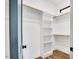 Organized walk-in closet with custom shelving and hardwood floors at 606 Velma Hopkins Ln, Raleigh, NC 27603