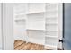 Organized walk-in closet with custom shelving and hardwood floors at 606 Velma Hopkins Ln, Raleigh, NC 27603