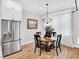 Cozy dining area with stainless steel refrigerator and natural light at 606 Velma Hopkins Ln, Raleigh, NC 27603